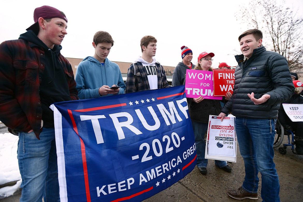 Braxton Shewalter, right, an organizer for the rally in support of President Donald Trump, speaks to attendees along East Center Street in Kalispell on Saturday. (Casey Kreider/Daily Inter Lake)