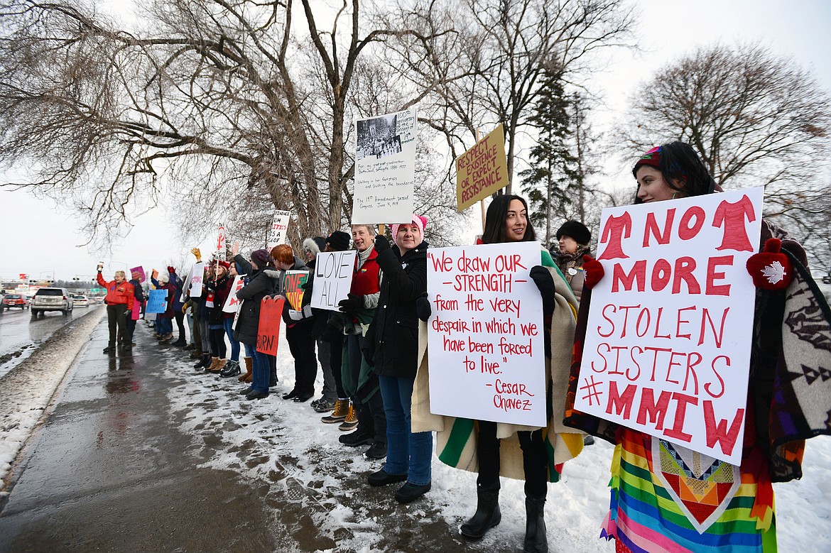 Attendees of the Kalispell Women's March hold signs along North Main Street outside Depot Park on Saturday. (Casey Kreider/Daily Inter Lake)