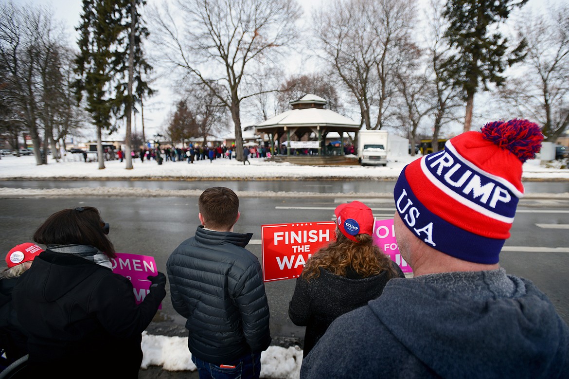 Attendees of a rally in support of President Donald Trump hold signs along East Center Street, across the street from the Kalispell Women's March held at Depot Park in Kalispell on Saturday. (Casey Kreider/Daily Inter Lake)