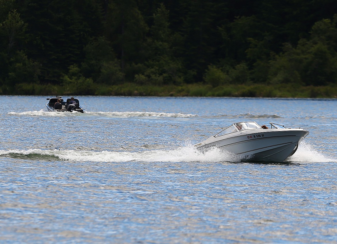 LOREN BENOIT/Press file
Two boats navigate the Spokane River last summer. Kootenai County commissioners on Tuesday unanimously approved a proposal to increase the night speed limit on waterways from 20 to 25 mph to reduce wakes and erosion and improve visibility for boaters.