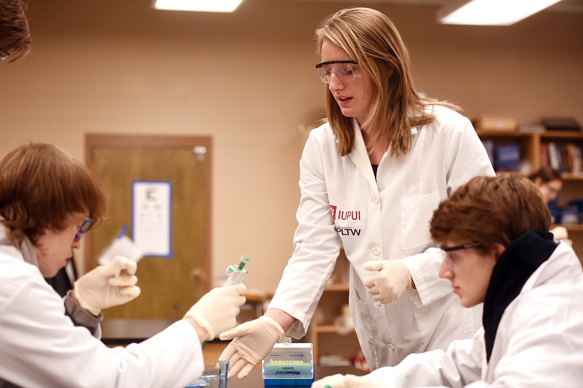 Linzi Napier helps Andrew Holmquist, left, and Garrett Hankowith on their current project in the Biomedical Science Lab at Flathead High School.
(Brenda Ahearn/Daily Inter Lake)