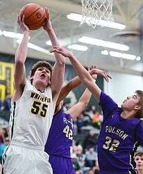 Whitefish's Dillon Botner (55) goes to the hoop past Polson's Kordell Walker (42) and Colton Graham (32) at Whitefish High School on Friday. (Casey Kreider/Daily Inter Lake)