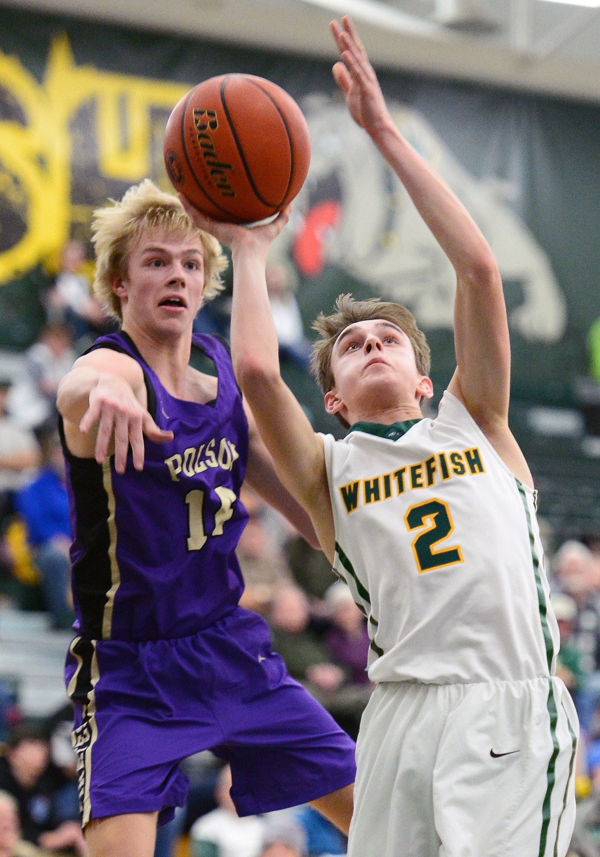 Whitefish's Bodie Smith (2) drives to the basket with Polson's Trevor Schultz (14) defending at Whitefish High School on Friday. (Casey Kreider/Daily Inter Lake)