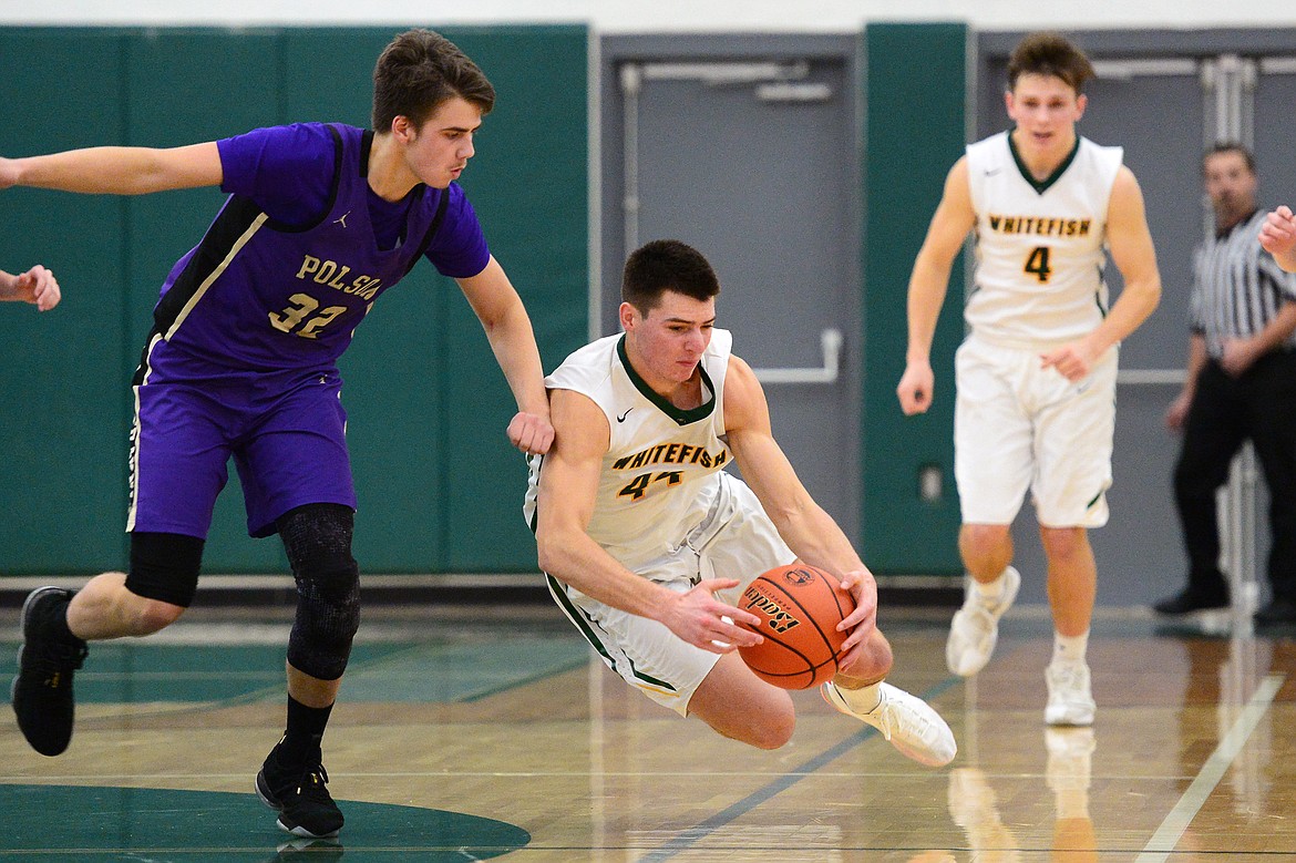 Whitefish's Lee Walburn (44) dives on a loose ball in the closing seconds of the fourth quarter to secure a 53-49 win over Polson at Whitefish High School on Friday. (Casey Kreider/Daily Inter Lake)