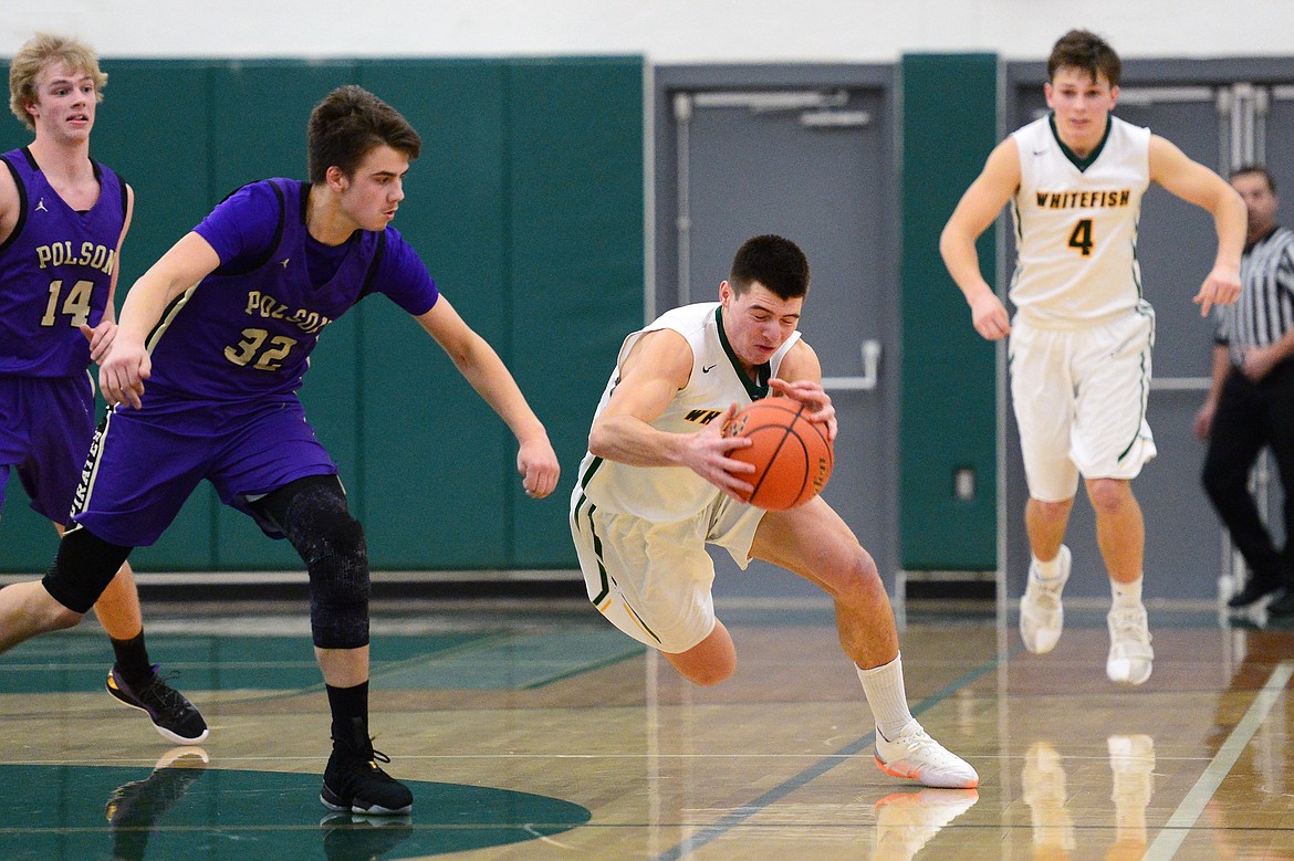 Whitefish's Lee Walburn (44) dives on a loose ball in the closing seconds of the fourth quarter to secure a 53-49 win over Polson at Whitefish High School on Friday. (Casey Kreider/Daily Inter Lake)