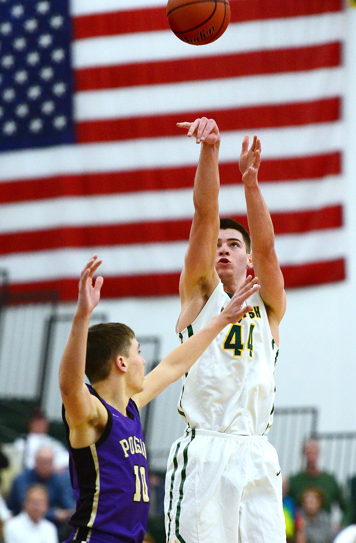 Whitefish's Lee Walburn (44) spots up for a three-pointer against Polson at Whitefish High School on Friday. (Casey Kreider/Daily Inter Lake)