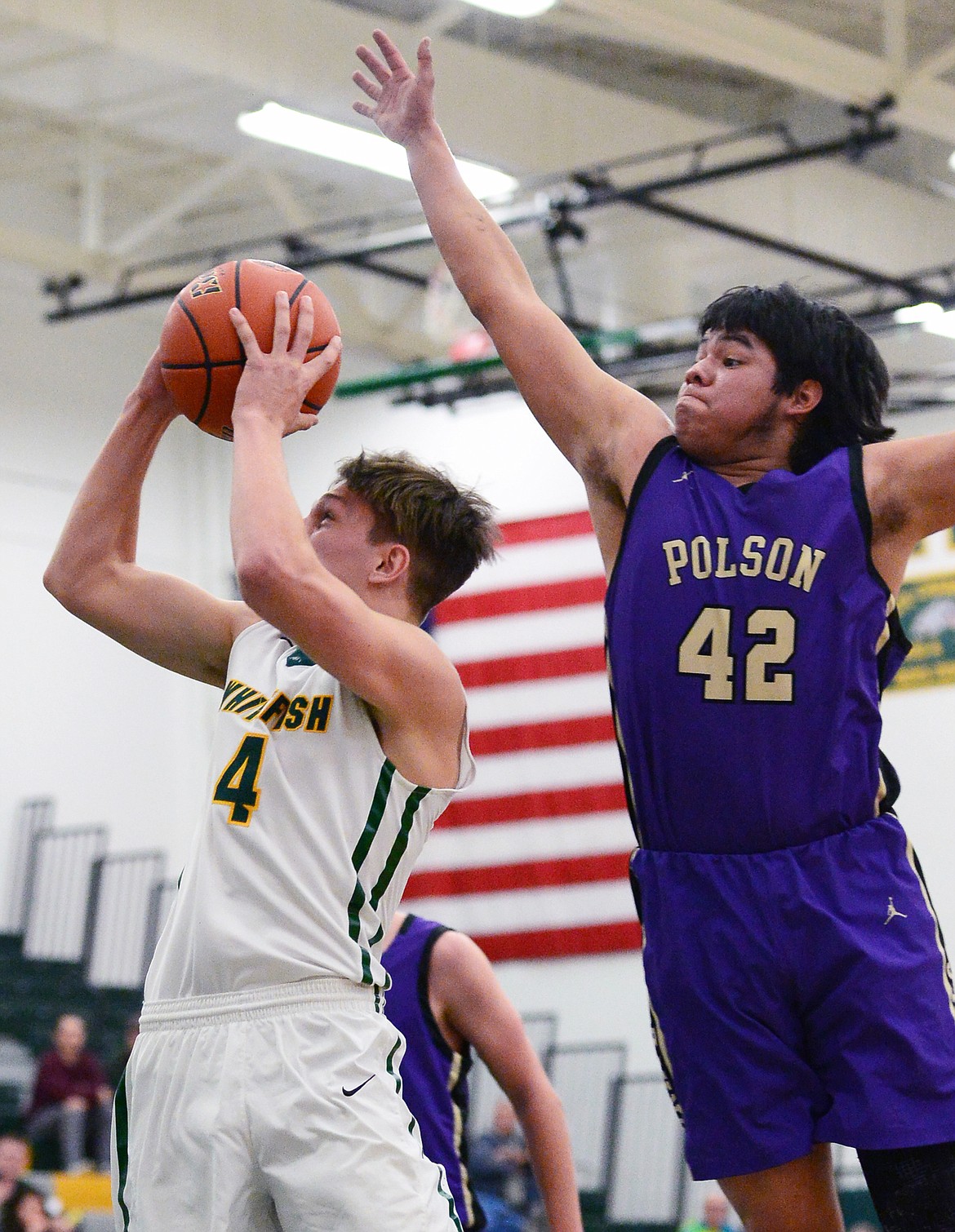 Whitefish's Jack Schwaiger (4) drives to the basket with Polson's Kordell Walker (42) defending at Whitefish High School on Friday. (Casey Kreider/Daily Inter Lake)