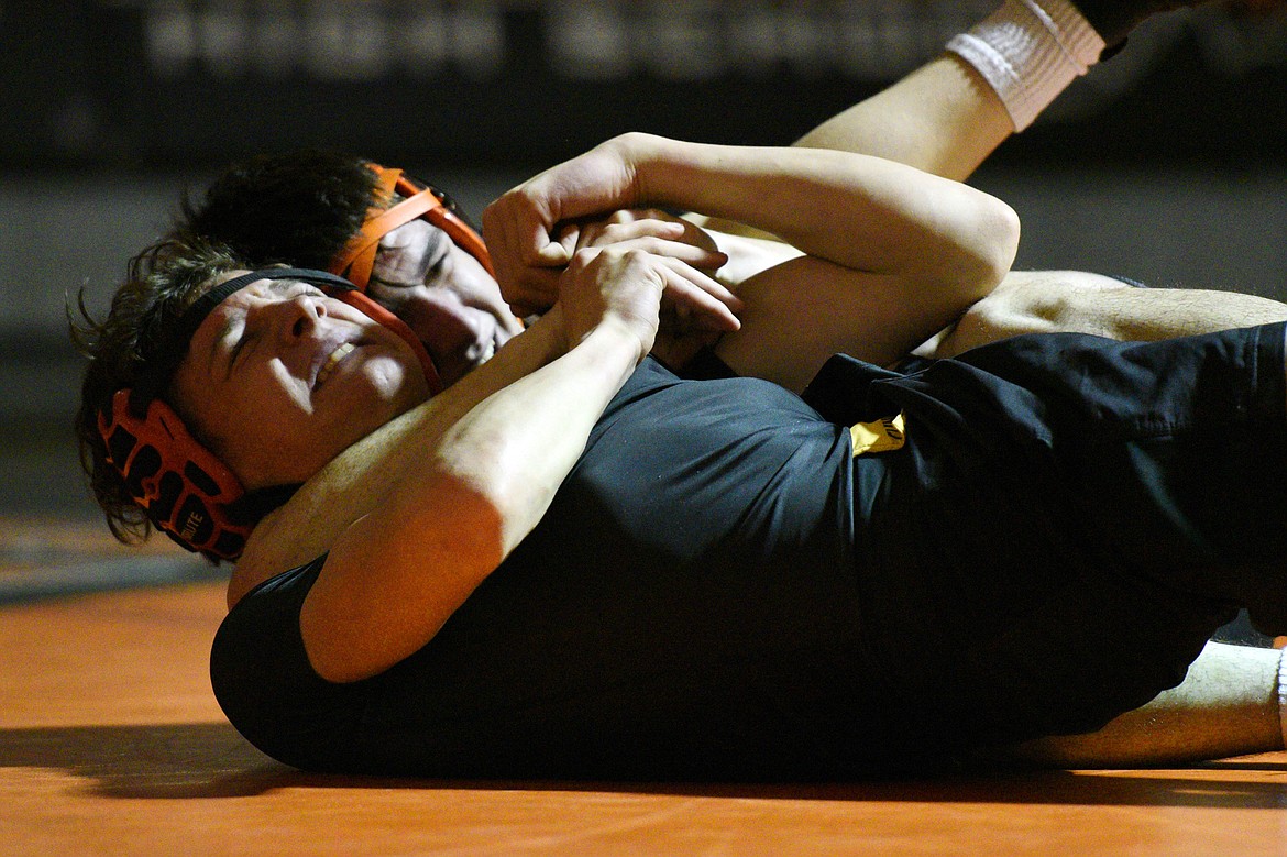 Flathead's Jaden MacNeil works toward a pin of Missoula Hellgate's Nick Ramsey at 138 lbs. at Flathead High School on Thursday. (Casey Kreider/Daily Inter Lake)