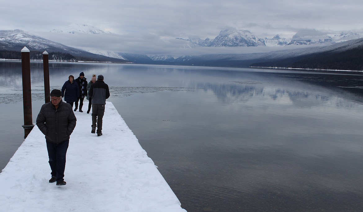 Ray Boksich (foreground) of Whitefish leaves a dock Wednesday at Lake McDonald at Glacier National Park. He is followed by his wife, Jerrie, and a young couple from Brazil, Angelo Silva and Leticia Souto. The Boksiches brought the Brazilians over to visit the park. Jerrie Boksich said the partial government shutdown &#147;has gone on too bloody long.&#148; (Duncan Adams/Daily Inter Lake)