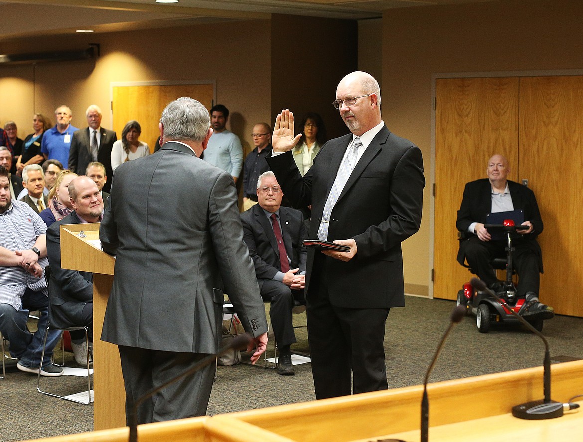 Kootenai County Coroner Warren Keene is administered the oath of office by Clerk Jim Brannon at Monday&#146;s swear-in ceremony. (LOREN BENOIT/Press)