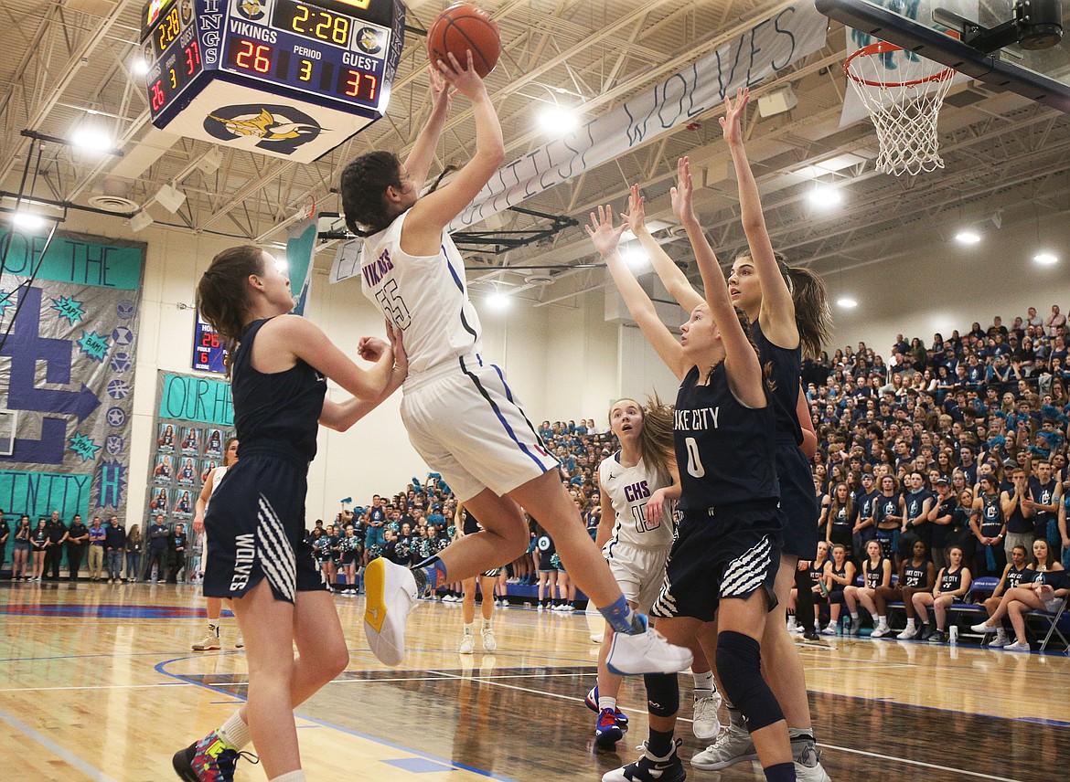 Lake City defenders Kendall Pickford (0), Sara Muehlhausen, right, and Aubrey Avery, left, try to disrupt Skylar Burke&#146;s shot in the third quarter of the girls game game.