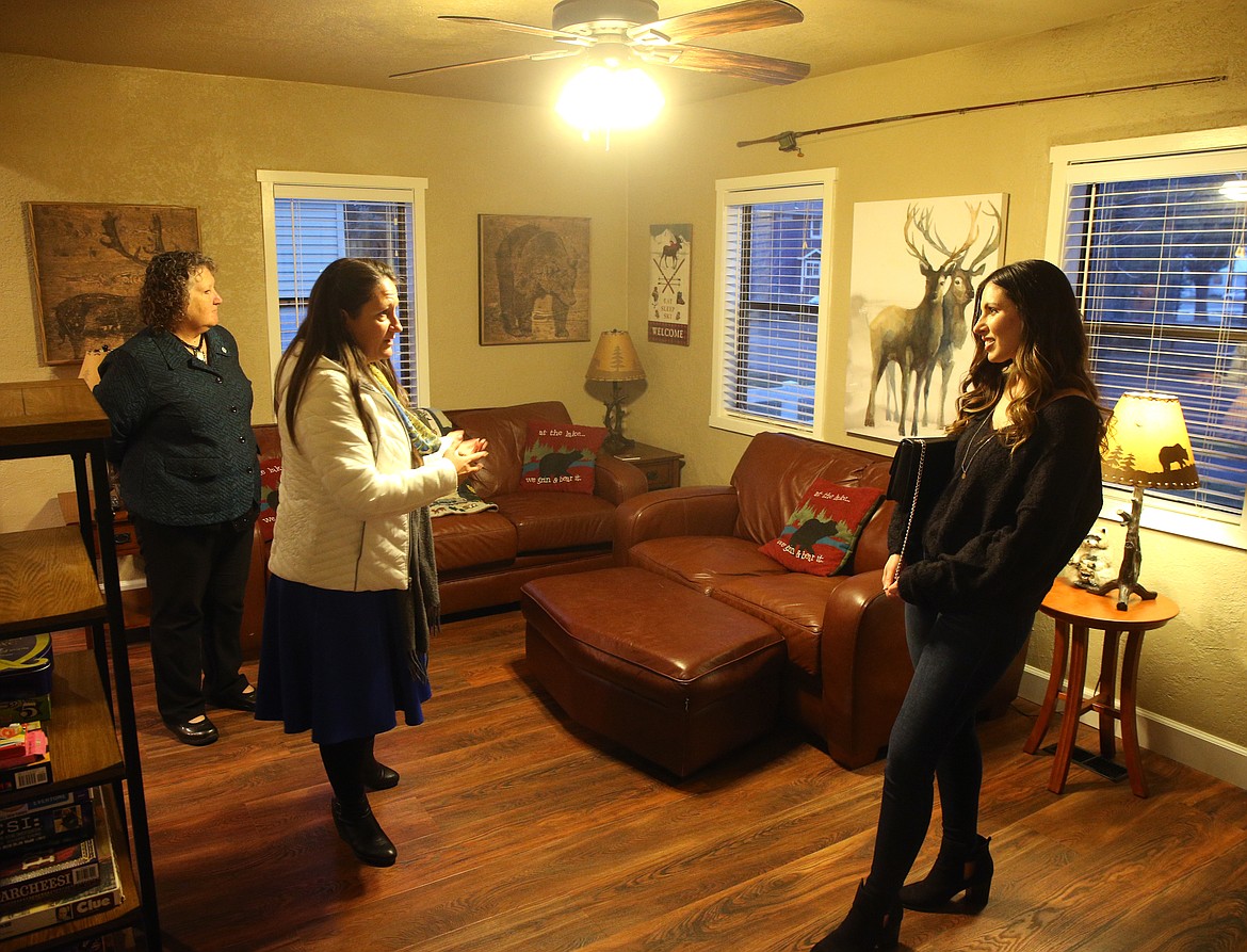 Windermere Real Estate agents Nancy and Holly Hansen, left, tour a home with Dominique Tetro, 28, Friday evening  along Lakeside Avenue. Dominique, a self employed graphic designer, moved to Coeur d'Alene from Boise a few months ago. (LOREN BENOIT/Press)