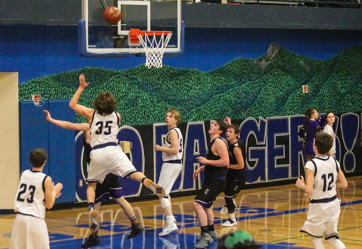 Bonners Ferry&#146;s Matt Morgan (35) shoots the ball, flanked by Hayden Stockton (23), Seth Bateman (5), and Dylan Hittle (12).