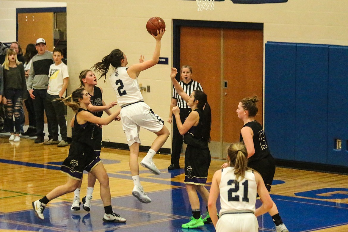 Photo by MANDI BATEMAN
Baylee Blackmore going for the score with Holly Ansley watching for the rebound.