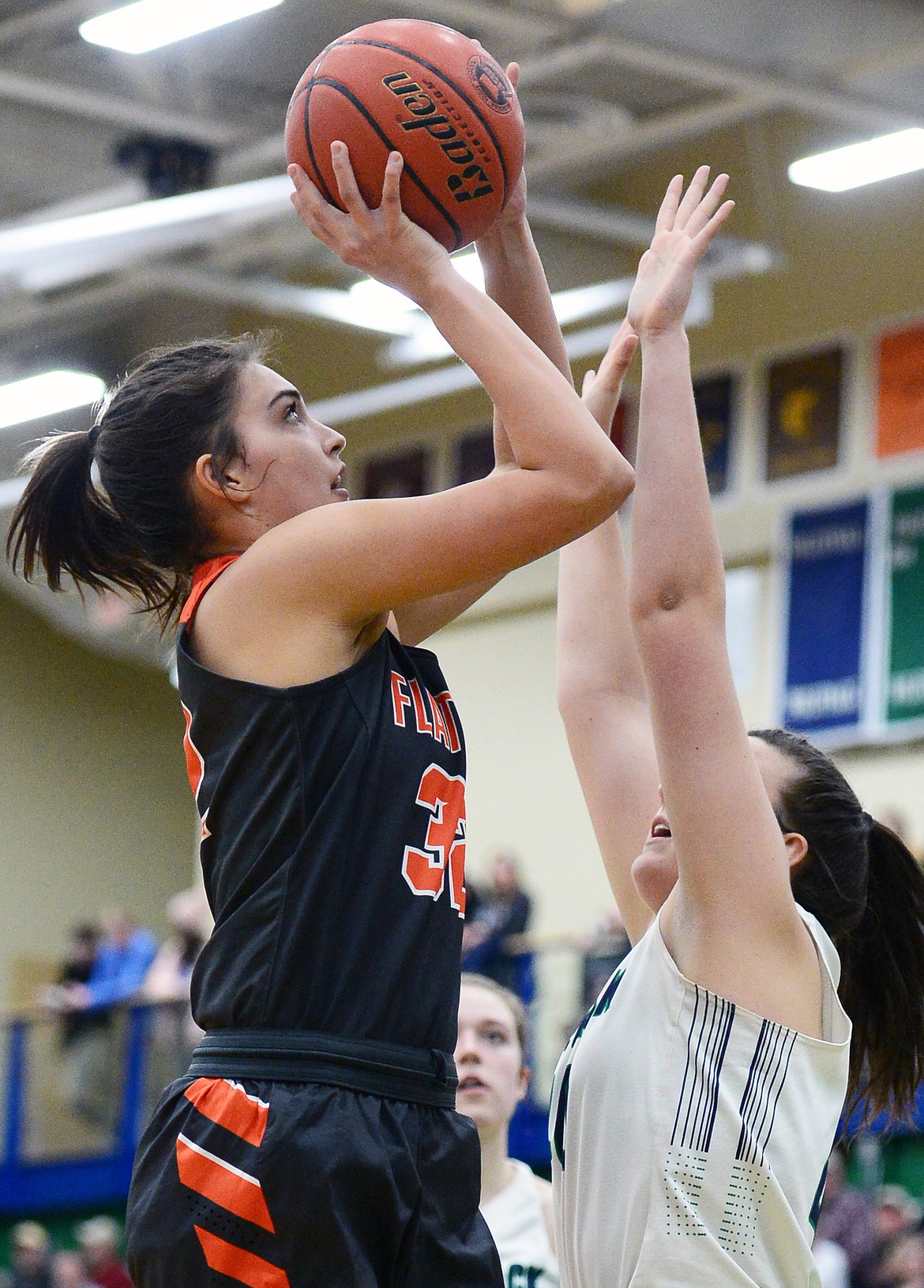 Flathead's Taylor Henley (32) shoots over Glacier's Raley Shirey (40) during a crosstown matchup at Glacier High School on Friday. (Casey Kreider/Daily Inter Lake)