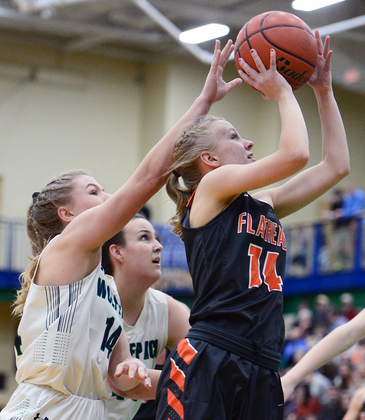 Flathead's Jenna Johnson (14) drives to the basket with Glacier's Aubrie Rademacher (14) defending during a crosstown matchup at Glacier High School on Friday. (Casey Kreider/Daily Inter Lake)