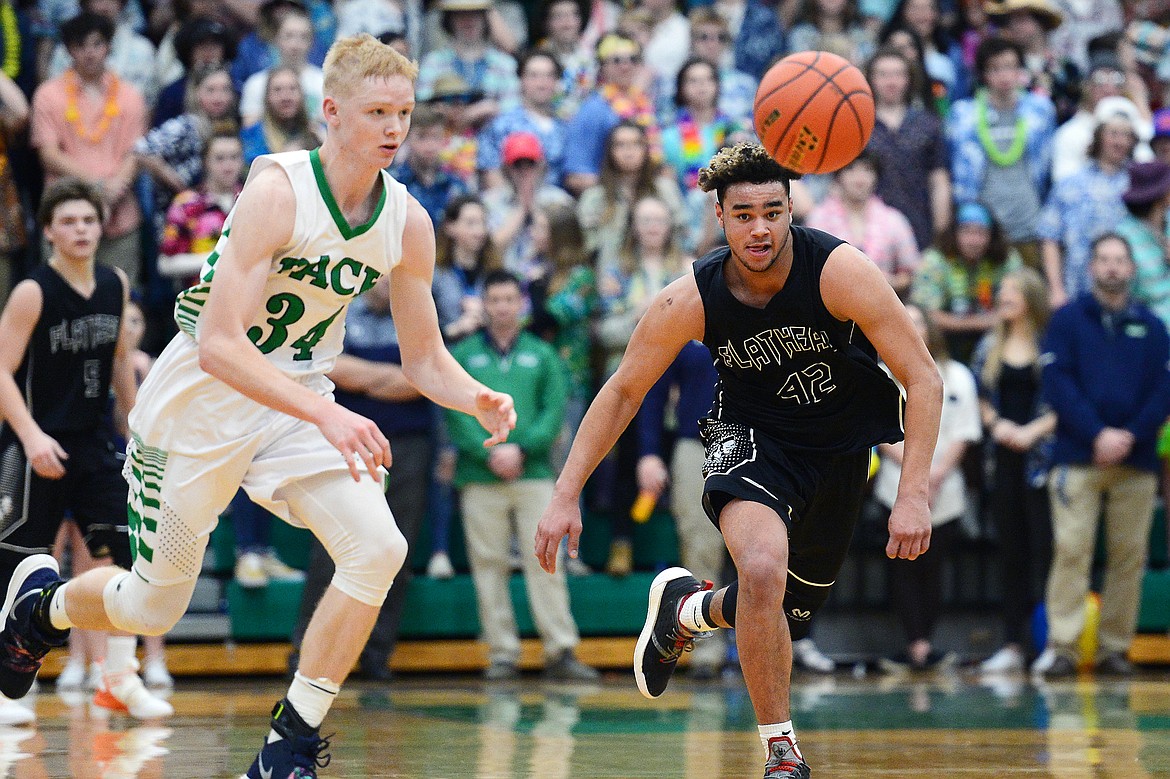 Glacier's Bret Michaels (34) and Flathead's Anthony Jones (42) chase down a loose ball during a crosstown matchup at Glacier High School on Friday. (Casey Kreider/Daily Inter Lake)