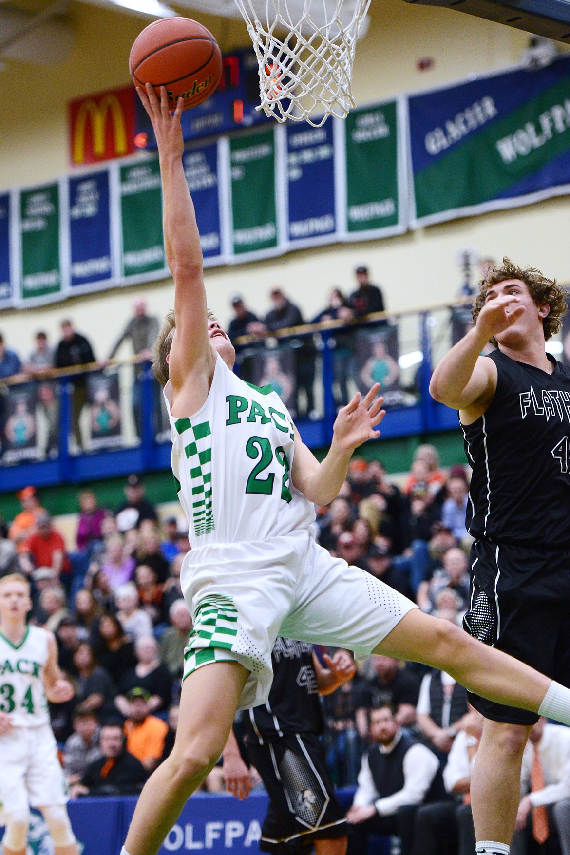 Glacier's Michael Schwarz (22) drives to the hoop past Flathead's Andrew Siderius (45) during a crosstown matchup at Glacier High School on Friday. (Casey Kreider/Daily Inter Lake)