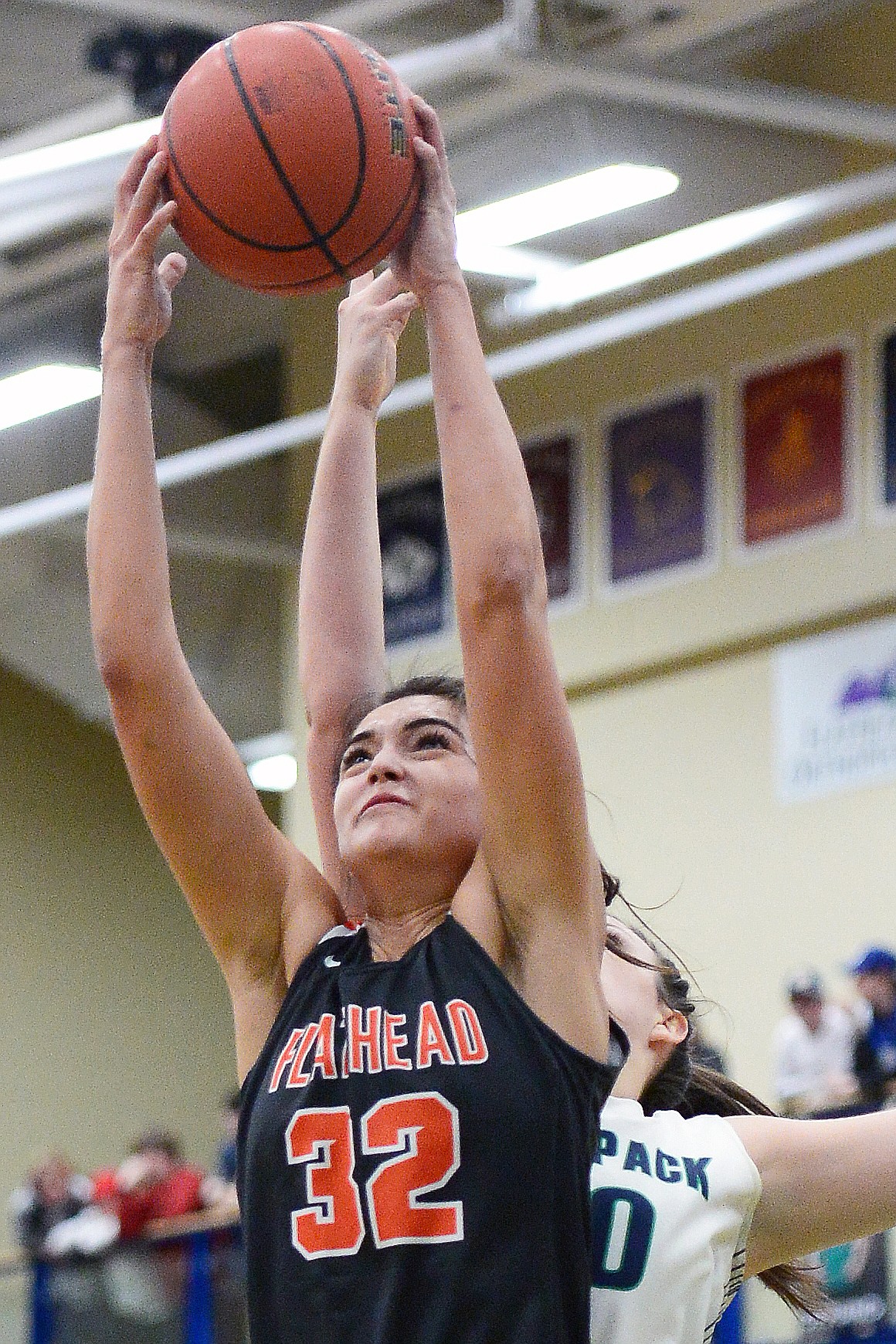Flathead's Taylor Henley (32) grabs a rebound over Glacier's Raley Shirey (40) during a crosstown matchup at Glacier High School on Friday. (Casey Kreider/Daily Inter Lake)