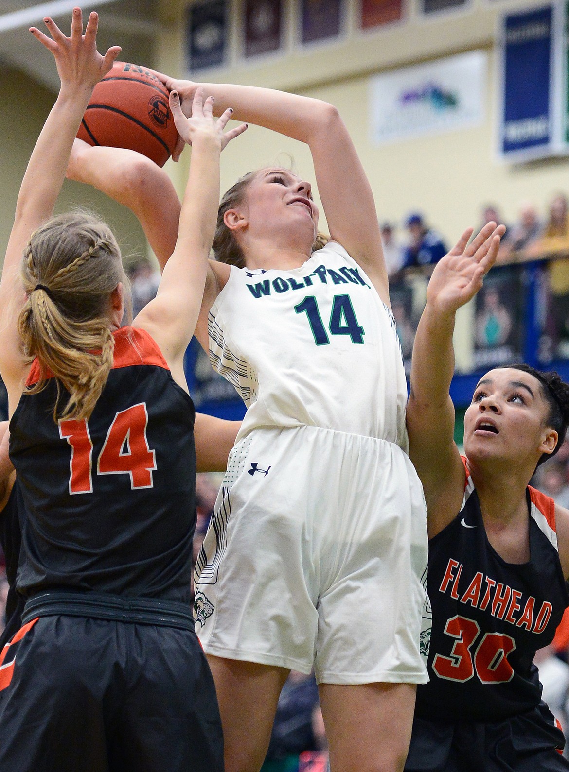 Glacier's Aubrie Rademacher (14) looks to shoot between Flathead's Jenna Johnson (14) and Kayla Martin (30) during a crosstown matchup at Glacier High School on Friday. (Casey Kreider/Daily Inter Lake)