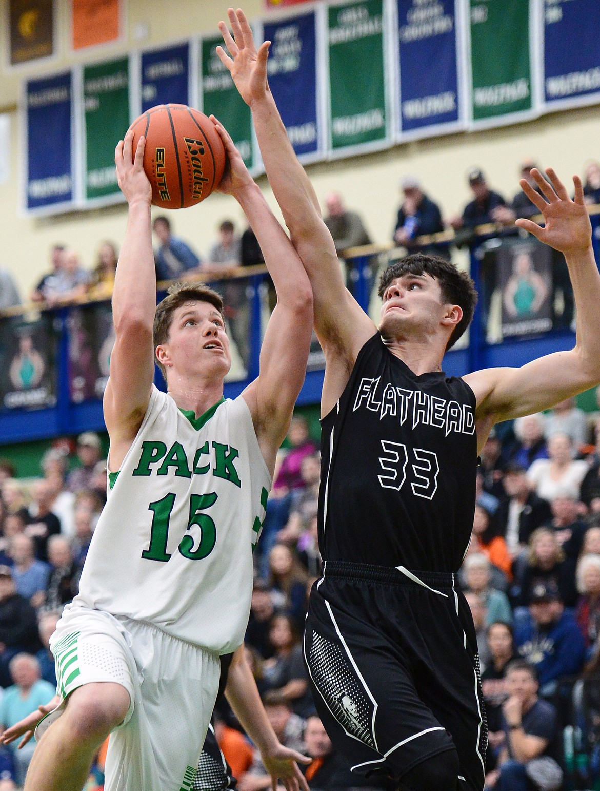 Glacier's Drew Engellant (15) drives to the hoop with Flathead's Gabe Adams (33) defending during a crosstown matchup at Glacier High School on Friday. (Casey Kreider/Daily Inter Lake)