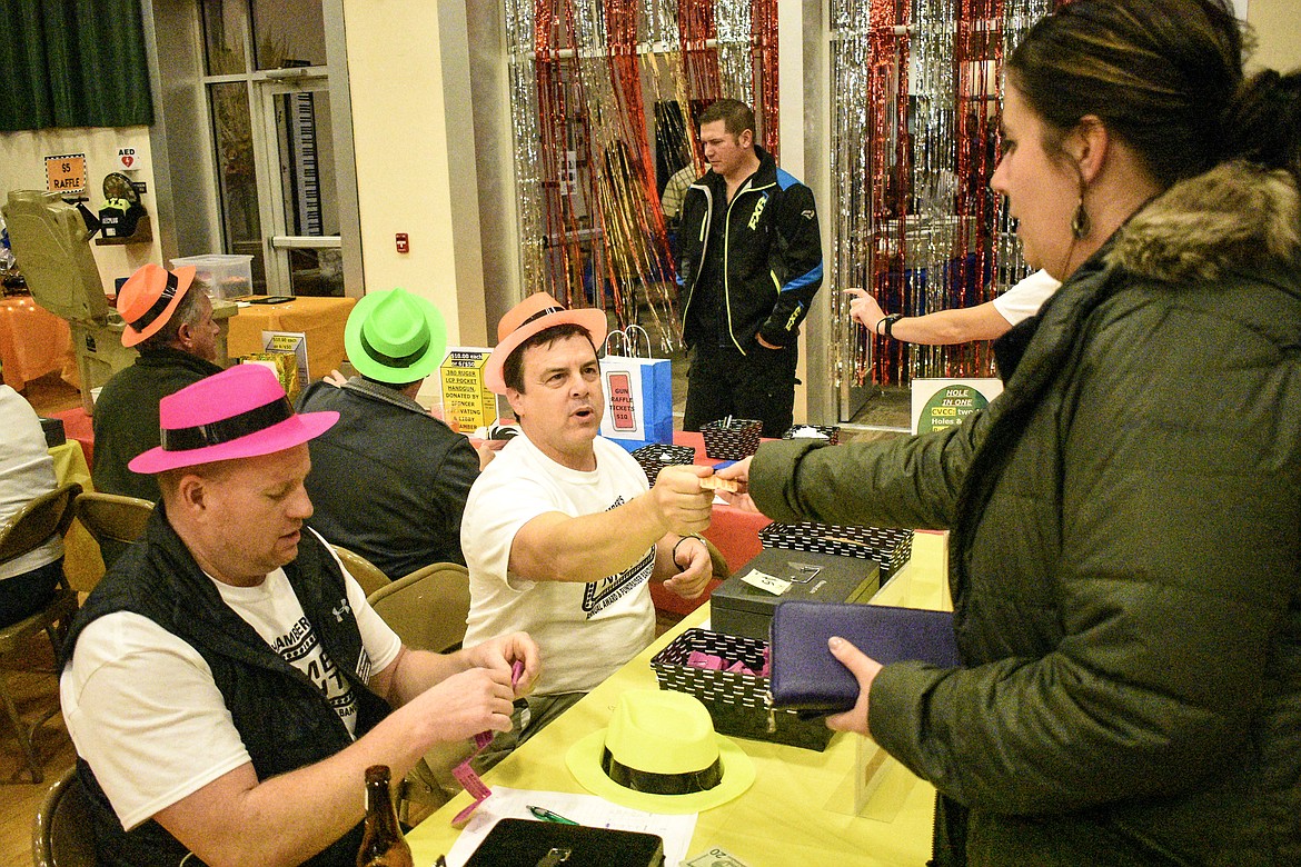 Libby Public Schools Curriculum/Special Services Director Scott Beagle and Superintendent Craig Barringer sell raffle tickets at the Libby Chamber of Commerce annual fundraiser and awards banquet Friday. (Ben Kibbey/The Western News)