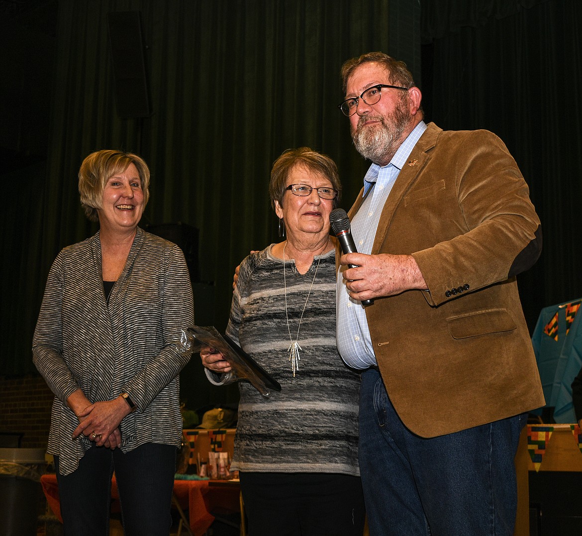 Lincoln County Commissioner Mark Peck presented the Lincoln County Employee of the Year Award to County Administrator Darren Coldwell by Skype at the Libby Chamber of Commerce annual fundraiser and awards banquet Friday. Coldwell was In Minnesota receiving medical treatment at the Mayo Clinic, and his mother Karren (center) and sister Allison Lundin received the plaque on his behalf. (Ben Kibbey/The Western News)