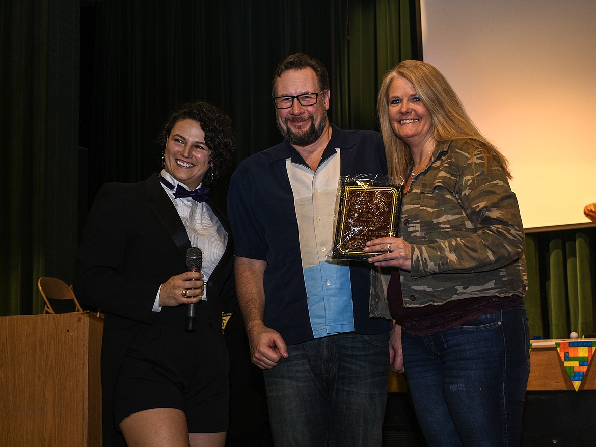 The Kootenai County Chainsaw Carving Championship won the Event of the Year award at the Libby Chamber of Commerce annual fundraiser and awards banquet Friday. Accepting the award from Chamber Secretary Liz Whalen were Troy Douthit and Melissa Cady. (Ben Kibbey/The Western News)