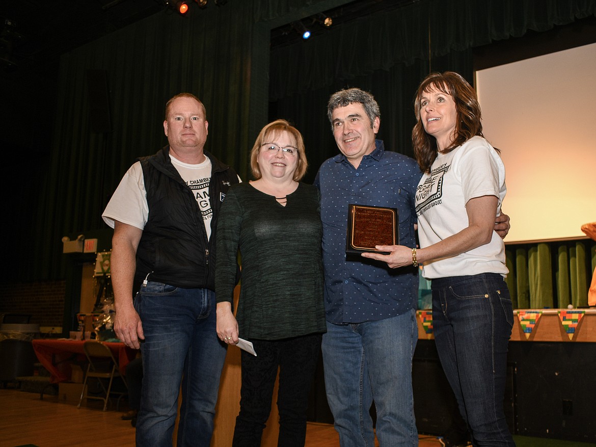 High Spirits Liquor and Wine won the Business of the Year award at the Libby Chamber of Commerce annual fundraiser and awards banquet Friday. Pictured are Chamber President Scott Beagle Penny and Frank Kyes and Vice President Kim Peck. (Ben Kibbey/The Western News)