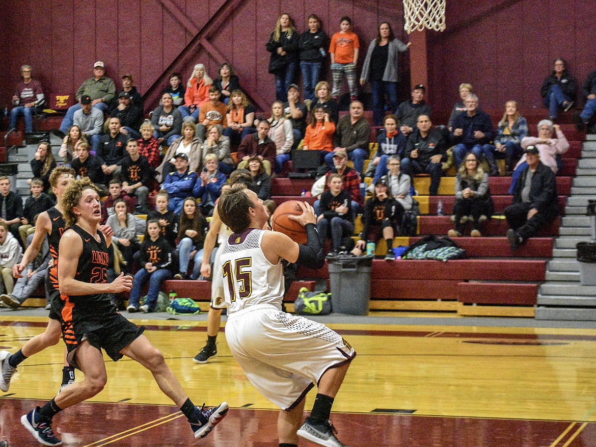 Troy senior Logan Milde goes in for a layup, snagging the Trojans a 38-34 lead over Eureka late in the final quarter Saturday. (Ben Kibbey/The Western News)