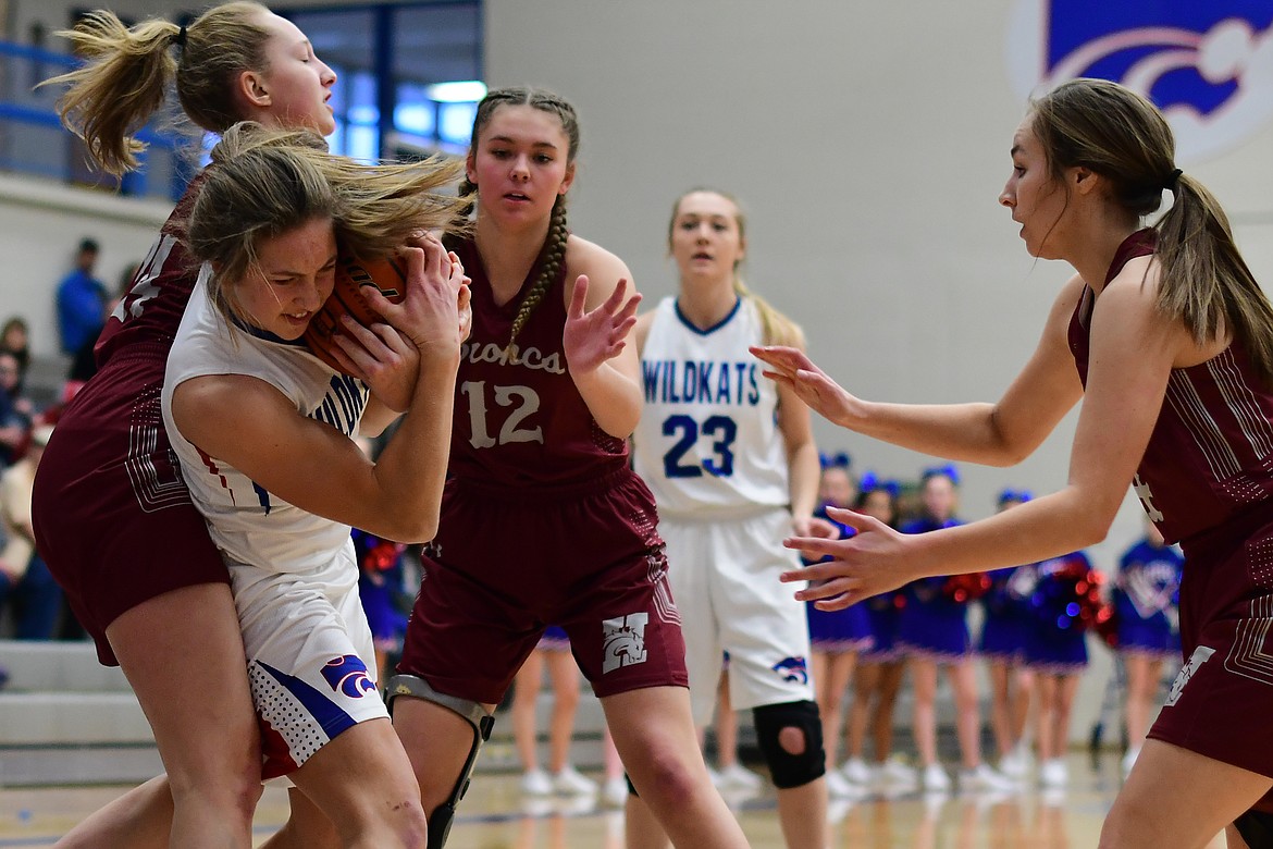 Wildkat Josie Windauer battles Hamilton&#146;s Lauren Ryter for a loose ball Saturday. (Jeremy Weber photo)