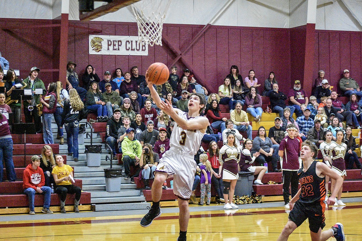 Troy senior Trevor Hoagland makes the final basket of the first half in the final seconds Saturday against Eureka. (Ben Kibbey/The Western News)