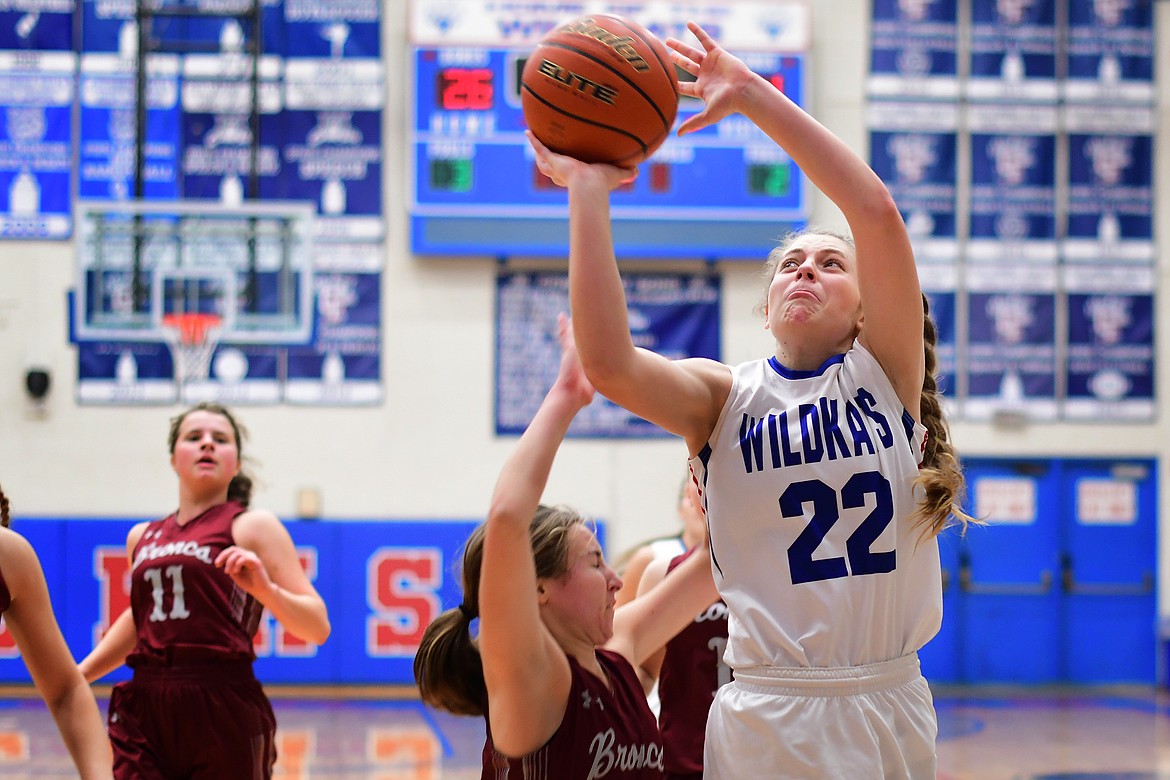 Wildkat Hannah Schweikert goes in for a tough shot against the Lady Broncs in Columbia Falls Saturday. (Jeremy Weber photo)