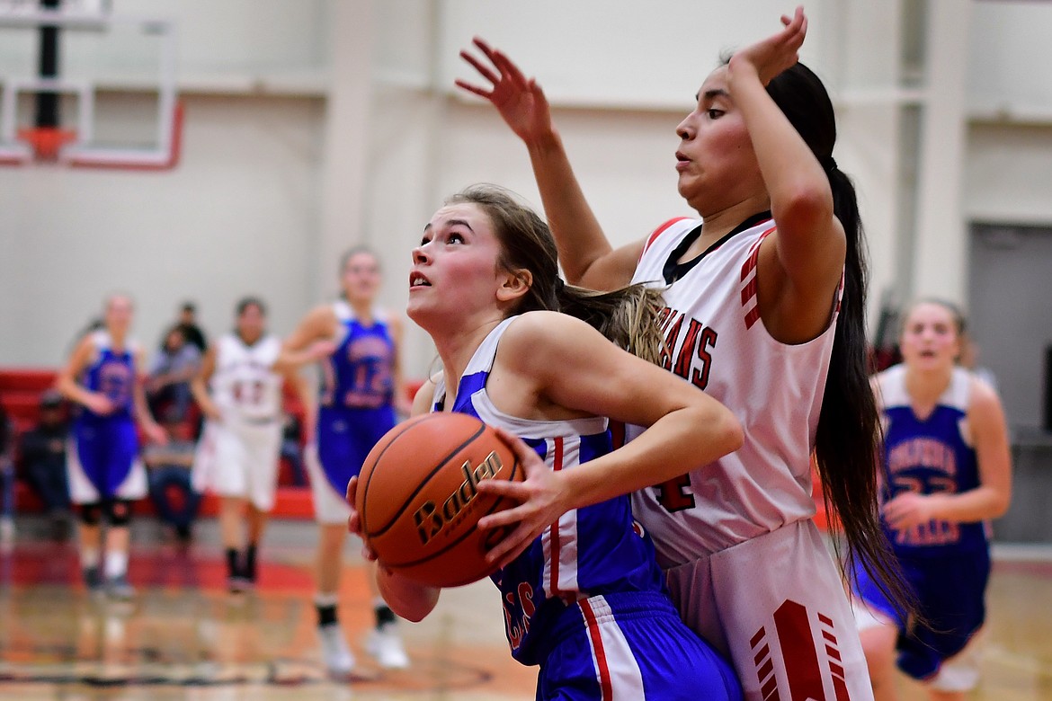 Maddie Robison takes the ball into the paint against the Lady Indians in Browning Thursday. (Jeremy Weber photo)