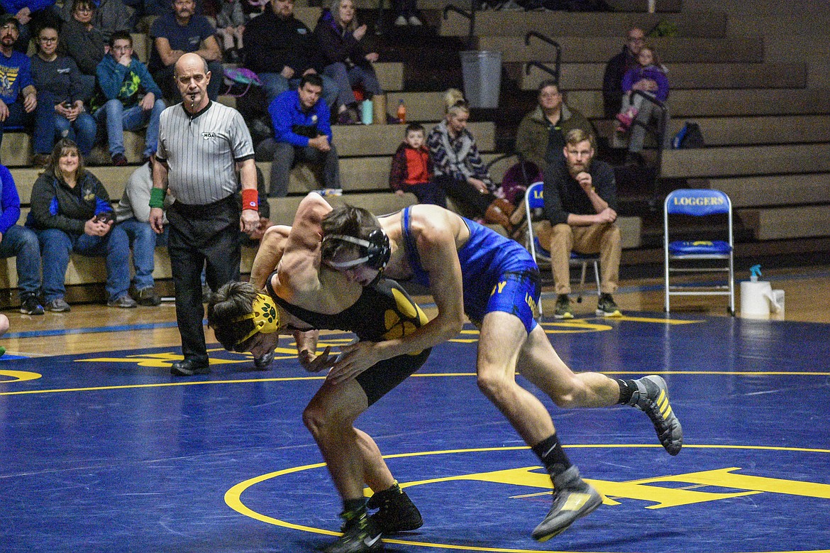 by senior Jeff Offenbecher grapples with Whitefish&#146;s Dakota Flannery as early in his match on Tuesday in Libby. Neither opponent was able to score a point until well into the second period. (Ben Kibbey/The Western News)