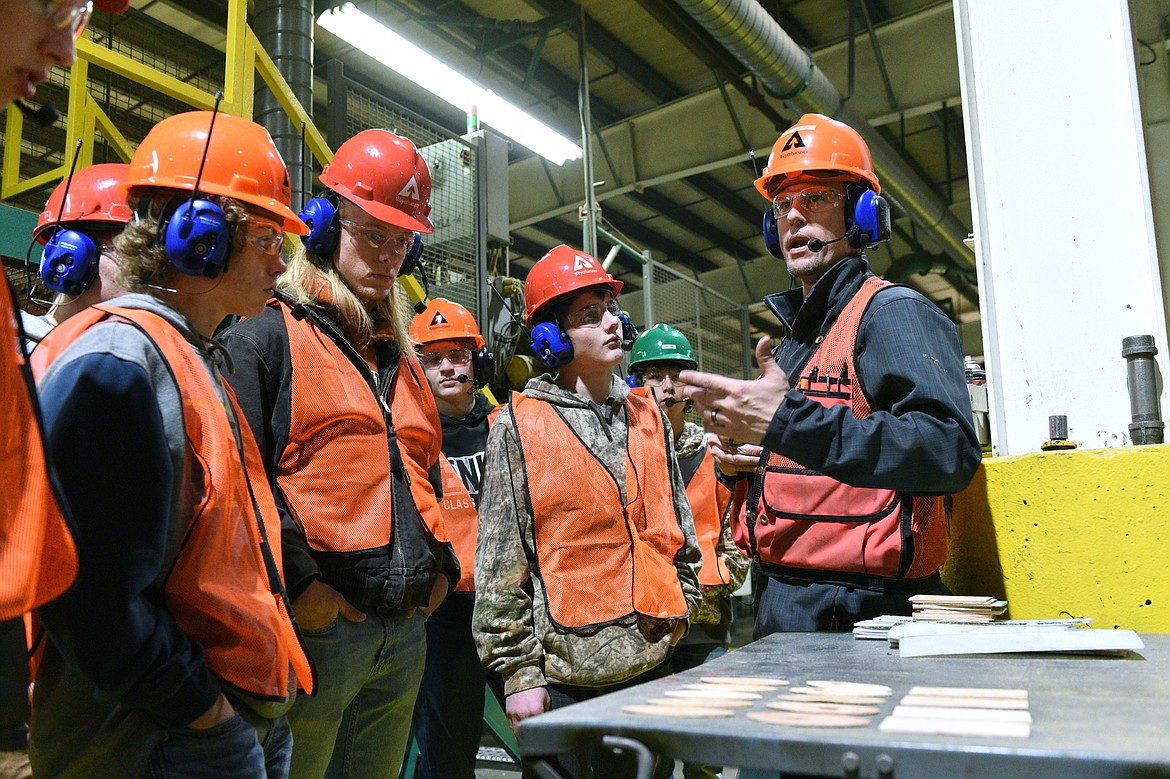 Travis Owen, right, a production scheduler at Weyerhaeuser, leads a group of Flathead High School students on a tour of the company&#146;s Evergreen facility. Second from left is Flathead High senior Vance Miller. (Casey Kreider/Daily Inter Lake)