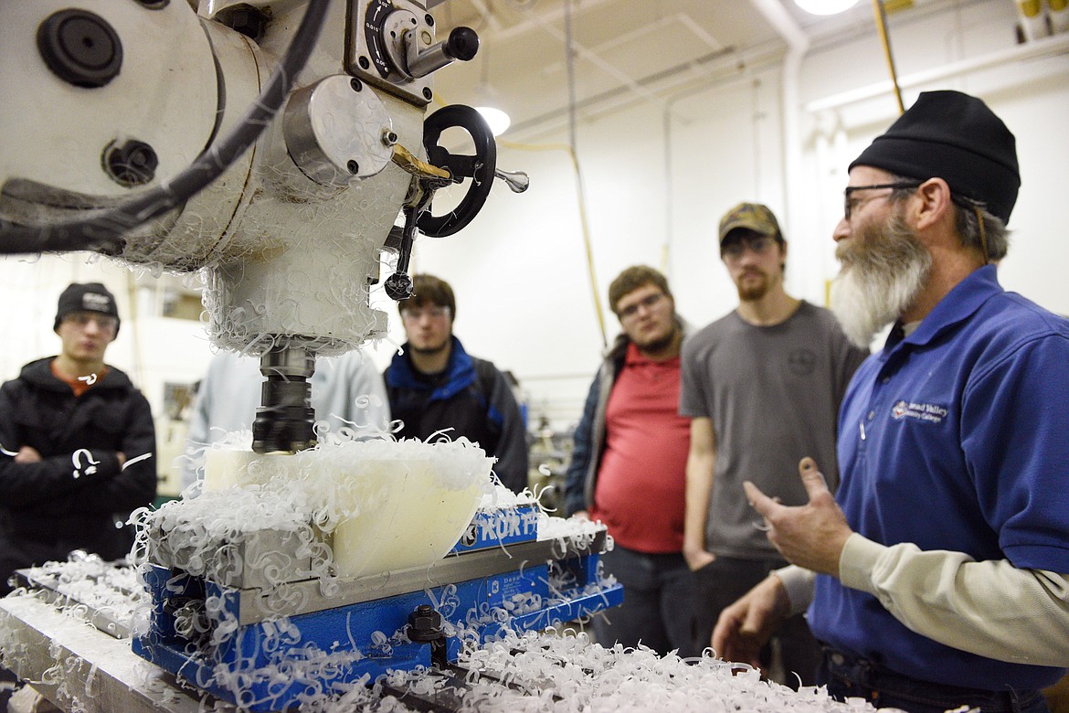 FVCC instructor Harry Smith describes using a manual mill to a group of Flathead High School students. (Casey Kreider/Daily Inter Lake)