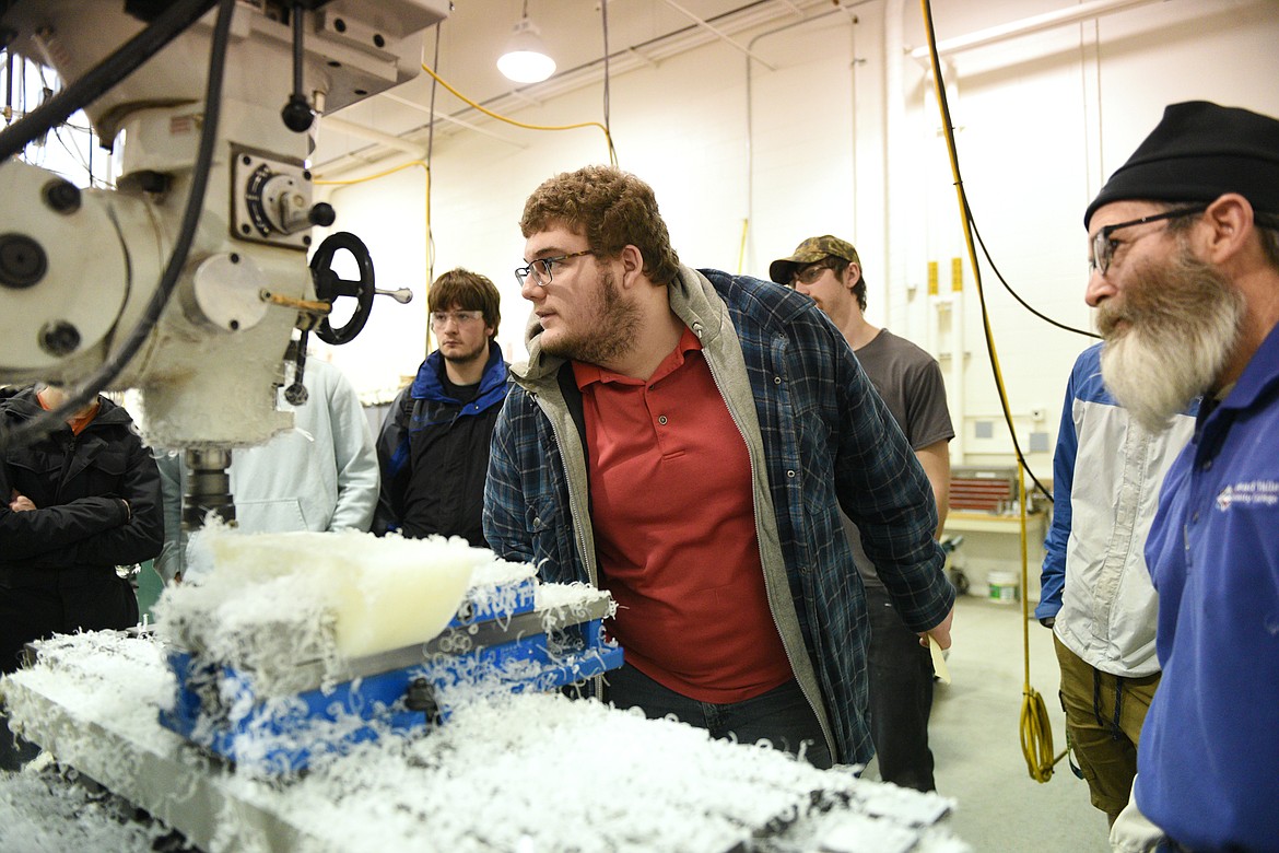 Flathead High students get hands-on experience working on a manual mill with FVCC instructor Harry Smith, right, during Pursuing the Trades at Flathead Valley Community College on Wednesday, Jan. 9. (Casey Kreider/Daily Inter Lake)