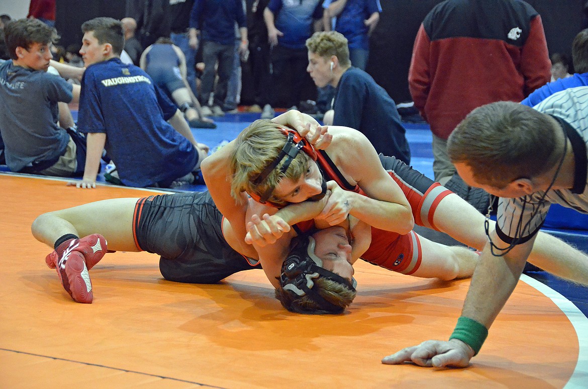 Kellogg wrestler and Wallace student works toward one of his five pinfalls during a match at the River City Duals.