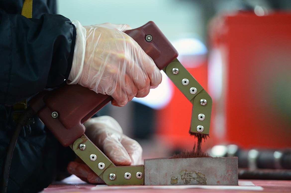 A student works with a field yoke, an electrical horseshoe-shaped magnet, in the firearms and non-destructive testing breakout session during Pursuing the Trades at Flathead Valley Community College on Wednesday, Jan. 9. (Casey Kreider/Daily Inter Lake)