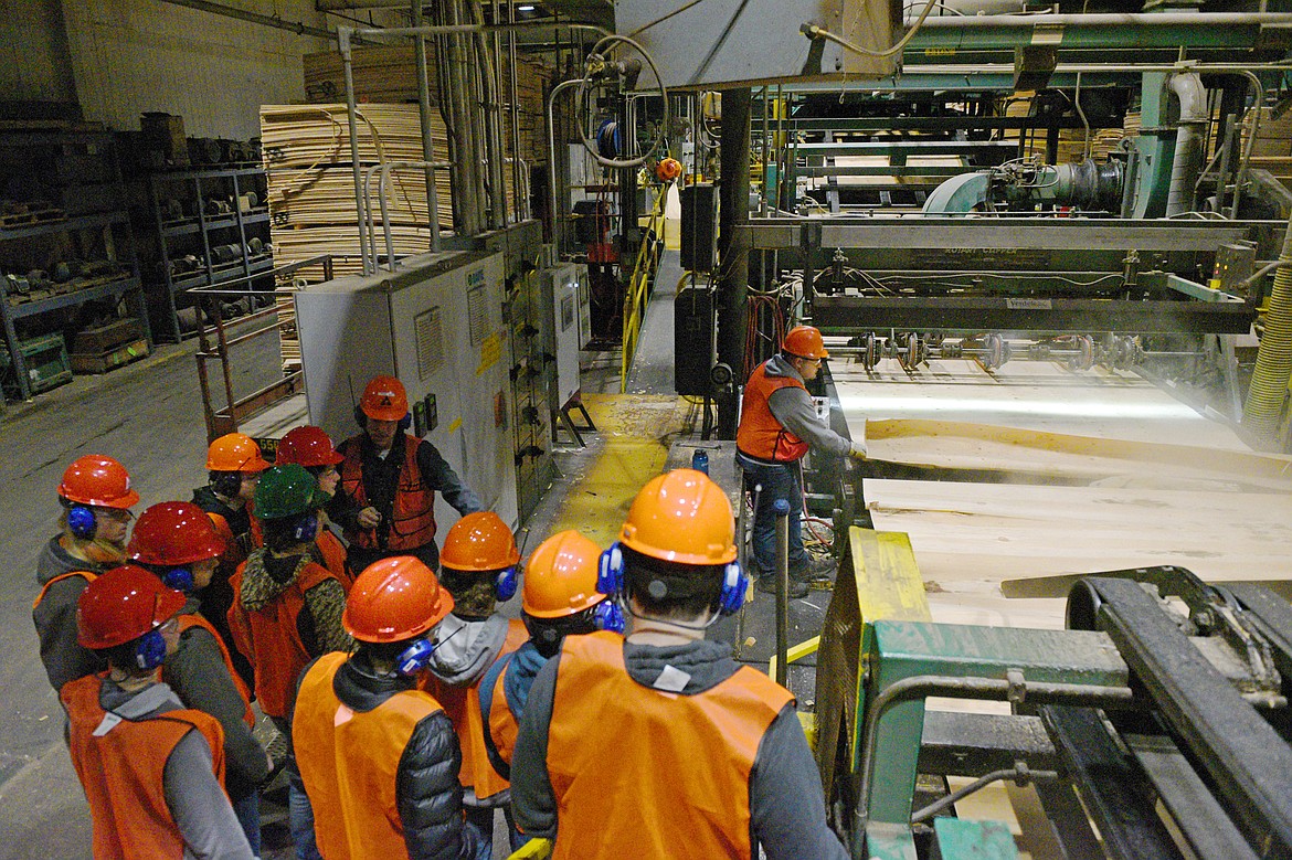 Travis Owen, a production scheduler at Weyerhaeuser, leads a group of Flathead High School students on a tour of their Evergreen facility on Wednesday, Jan. 9. (Casey Kreider/Daily Inter Lake)