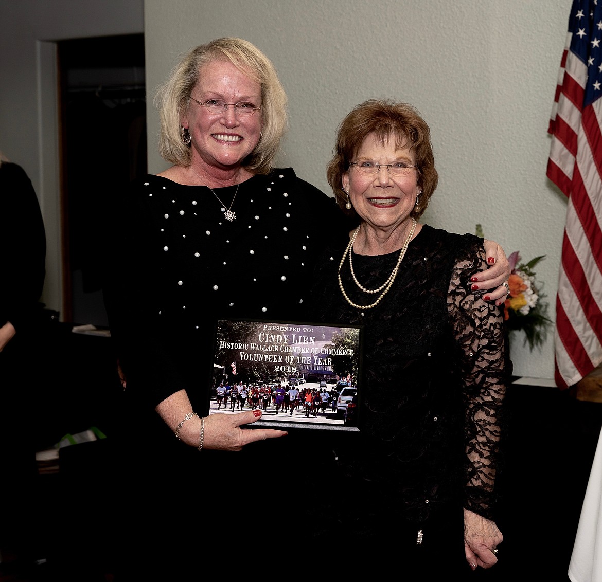 Cindy Lien (left) receives her Wallace Chamber of Commerce award for Volunteer of the Year from Anita Price.