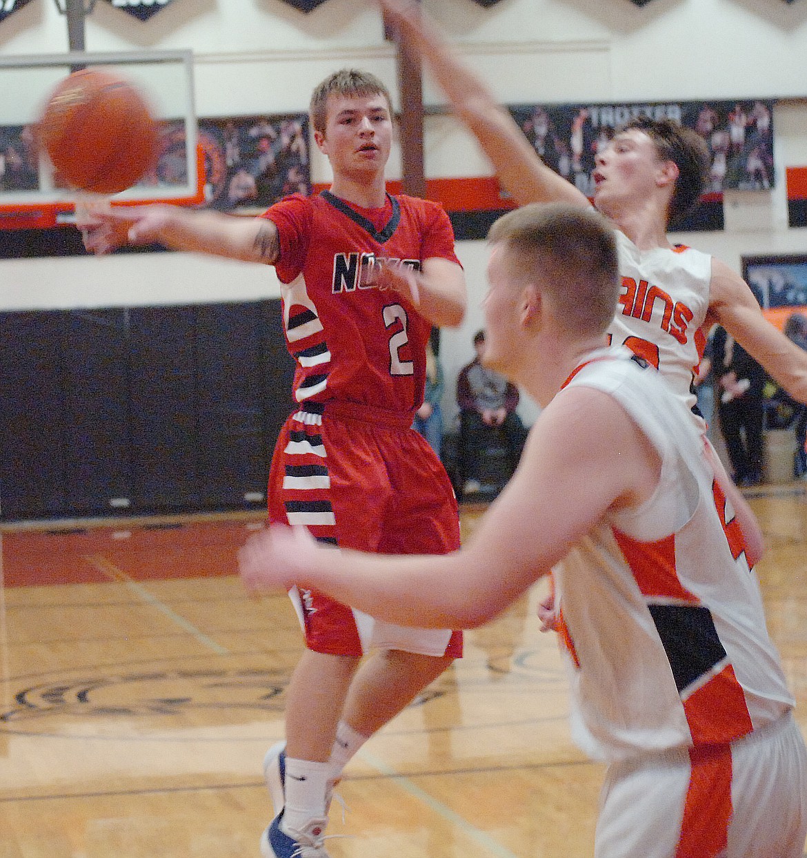 Noxon&#146;s Logan Wood (2) dishes off to a teammate while being guarded by Treydon Brouillette of Plains during last Friday&#146;s District 14C contest. The Horsemen earned a 30-33 victory. Also pictured is Derick Curry of Plains. (Joe Sova/Clark Fork Valley Press)