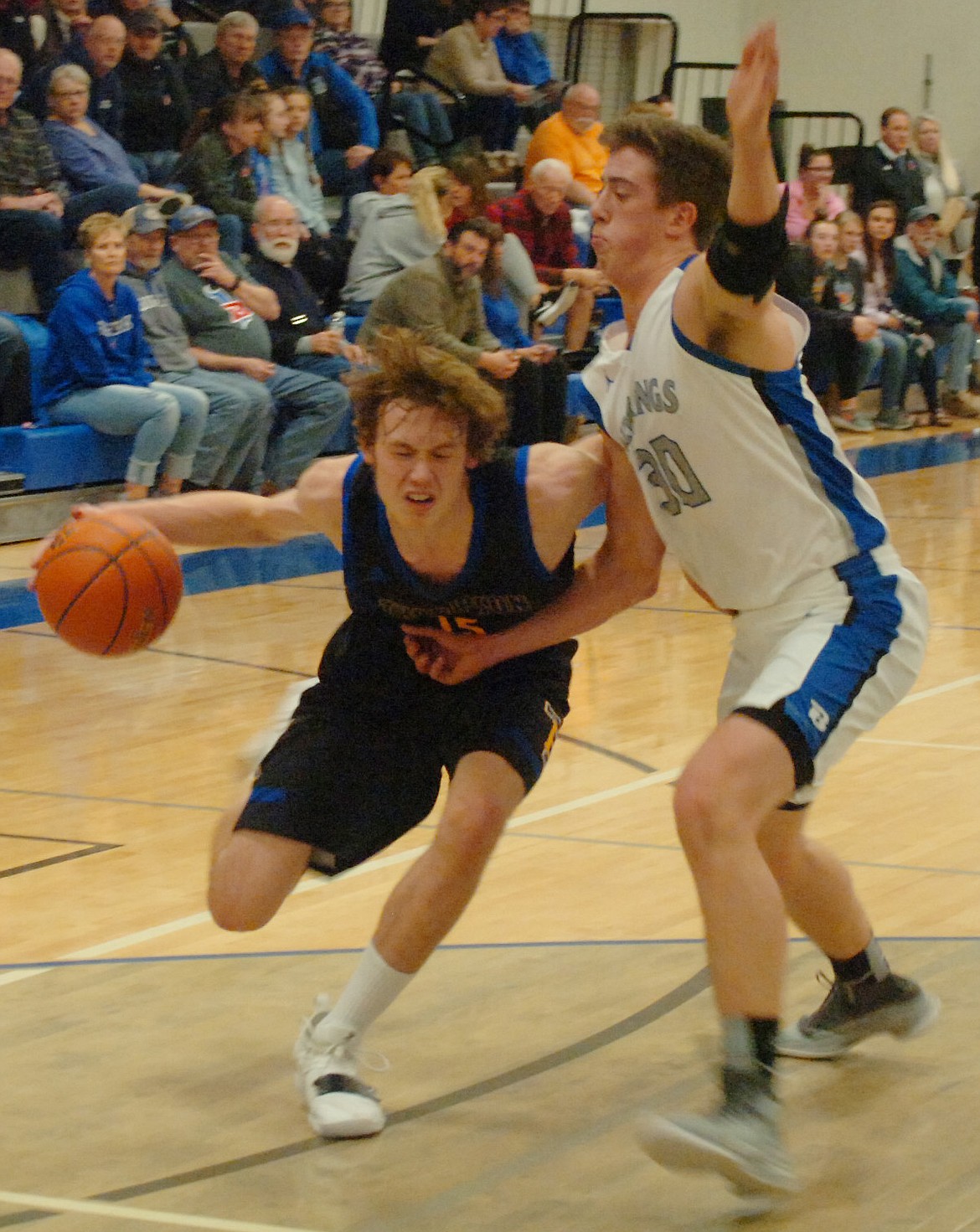 Thompson Falls senior Grant Lundberg drives to the hoop against Logan Gilliard of Bigfork during a District 7B road game last Thursday, Jan. 10. While Lunderg led the Bluehawks with 17 points, Gilliard netted 29 for the defending Class B state champion Vikings, who posted a 63-31 win. (Joe Sova/Clark Fork Valley Press)