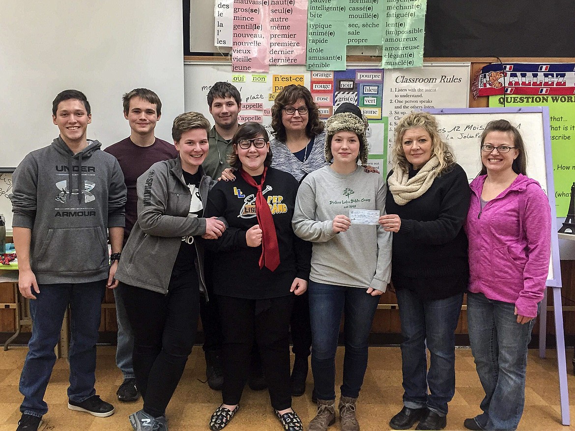The Kootenai Karacters theater troop presented a donation for $200 to members of the Libby High School speech and drama team last week. The money will go toward matching sweatshirts for team meets. Pictured are: (Back) Justin Brewer, Ethan Neff, David Hawkins and Coach Kim Lee. (Front) Autumn Fajotina, Taryn Thompson, Suvari Neff, Kootenai Karacters Vice President Cynthia Curtis and Kootenai Karacters President Amy Smart. Not pictured: team members Daron Levine and Noah Boyd. (Courtesy photo)
