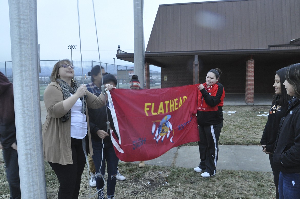 Students of the Native American Culture Club at Ronan HIgh School raise their Confederated Salish and Kootenai Tribes flag Monday, Jan. 14. (Ashley Fox/Lake County Leader)