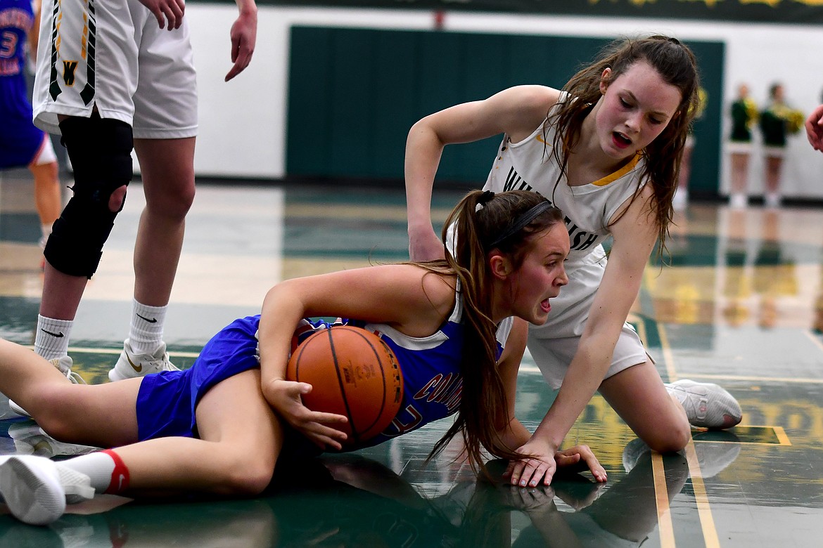 Paige Burger battles Whitefish&#146;s Kaiah Moore for a loose ball in the fourth quarter Thursday. (Jeremy Weber photo)