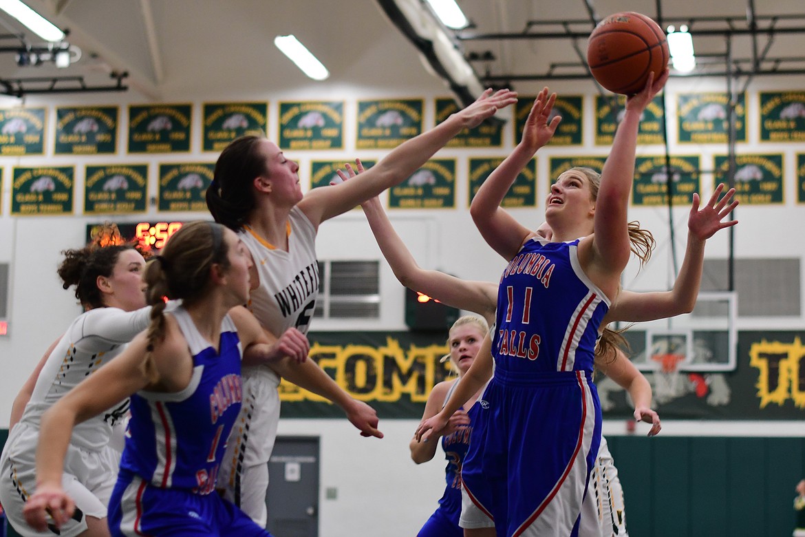 Savvy Ellis goes up for a contested shot against the Bulldogs in Whitefish Thursday. (Jeremy Weber photo