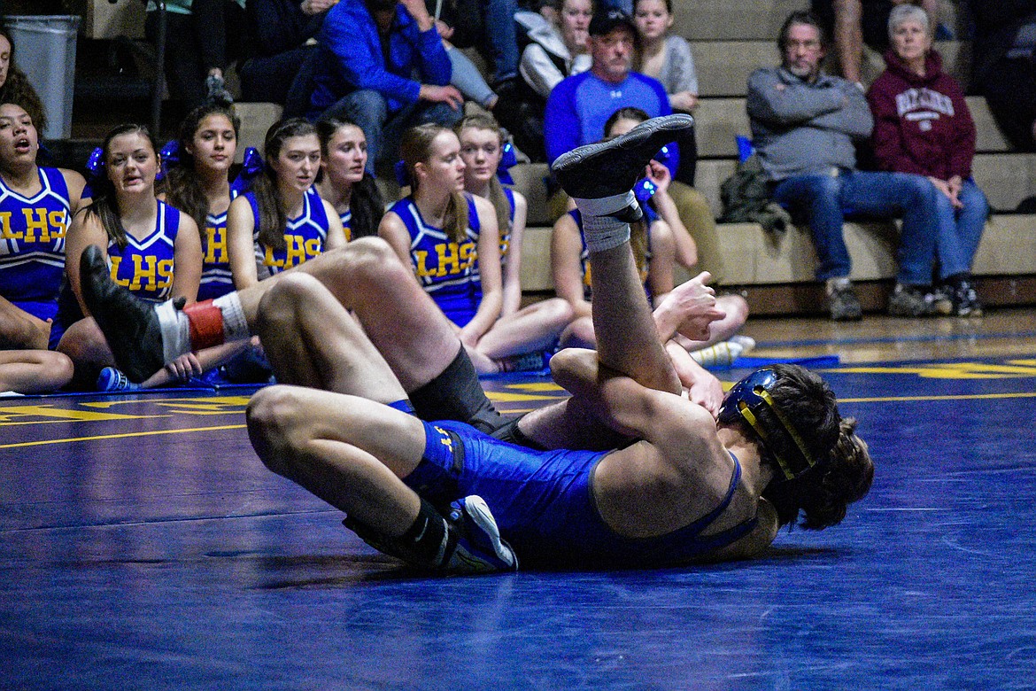 Libby sophomore Cody Crace works Sandpoints Neal Causey into a fall about a minute into their match Jan. 3 in Libby. (Ben Kibbey/The Western News)