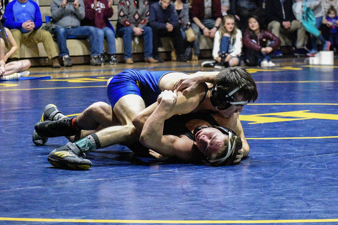 Libby senior Jeff Offenbecher gets a takedown on Sandpoint&#146;s Malachi Fleck, Jan. 3 in Libby. (Ben Kibbey/The Western News)